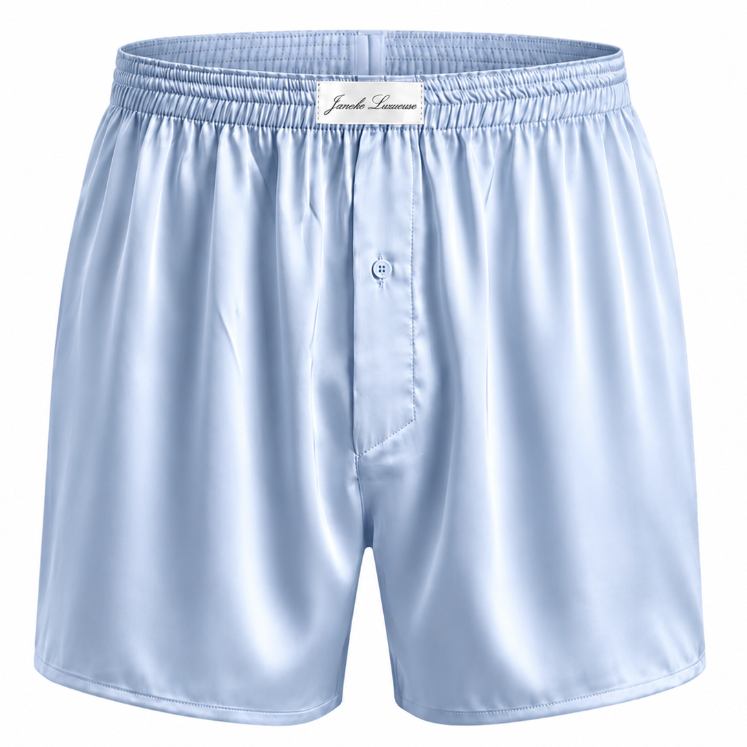 Light blue satin boxer shorts on a white background