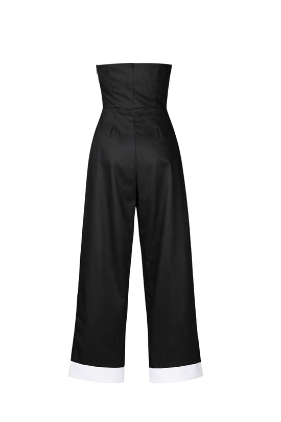 Black jumpsuit with white cuffs on a white background