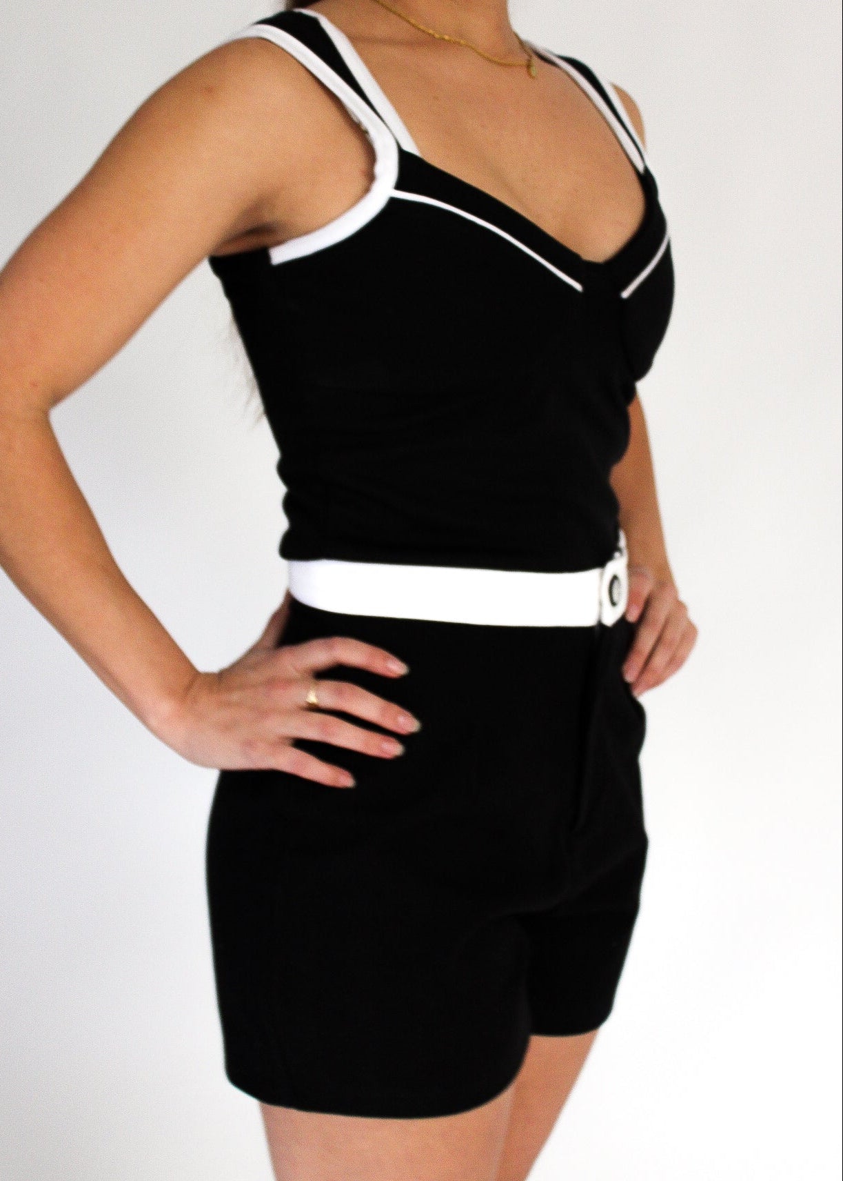 Black tank top and shorts set with white trim on a plain background