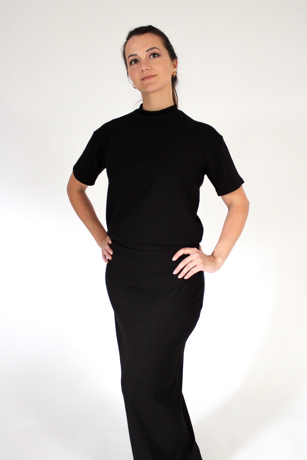 Woman wearing a black dress against a white background
