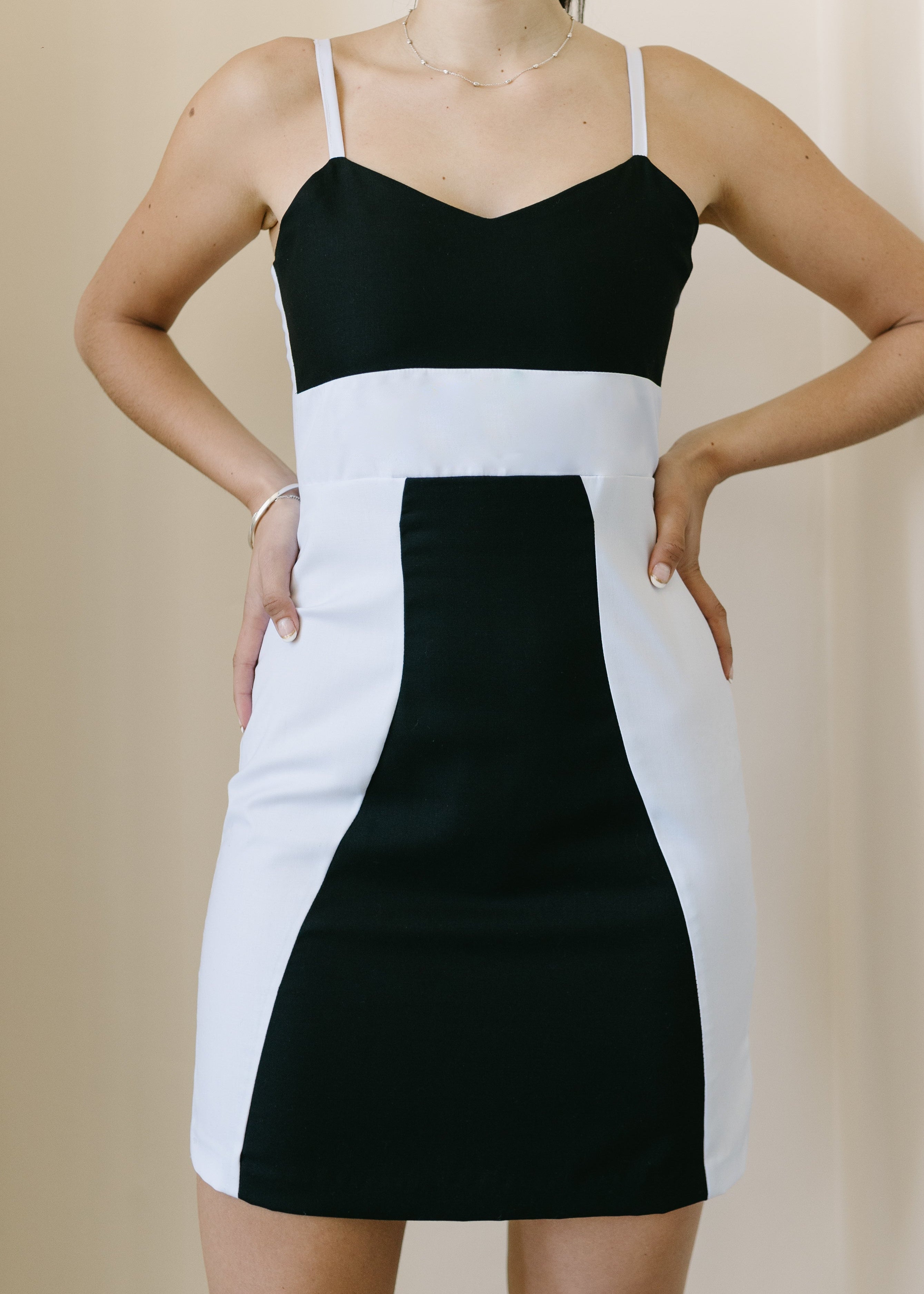 Black and white dress worn by a person on a beige background